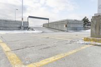 an intersection in the snow with one side showing and the other showing yellow painted on it