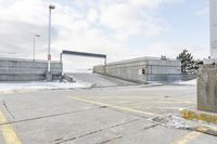 an intersection in the snow with one side showing and the other showing yellow painted on it