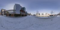 this view shows the snow and buildings from a fish - eye lens at one point