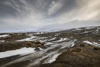 an image of a car on the dirt road in the snow outside of a country