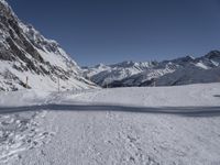 there are tracks of snow left by skiers on the slopes in this snowy area