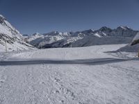 there are tracks of snow left by skiers on the slopes in this snowy area