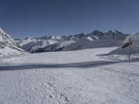 there are tracks of snow left by skiers on the slopes in this snowy area