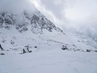 a skier is coming down the snowy mountain side with his skis down his right hand