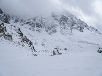 a skier is coming down the snowy mountain side with his skis down his right hand