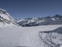 the path going down to a ski slope is very wide and very high, with snow on the ground