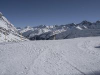 the path going down to a ski slope is very wide and very high, with snow on the ground