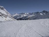 the path going down to a ski slope is very wide and very high, with snow on the ground