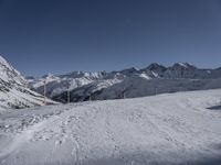 the path going down to a ski slope is very wide and very high, with snow on the ground