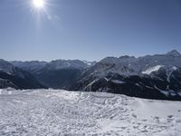 the snow covered area of a mountain with a person on skis in the middle of the mountain