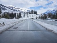 the view out of the car window of a snowy mountain road in the mountains of idaho