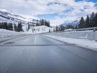 the view out of the car window of a snowy mountain road in the mountains of idaho