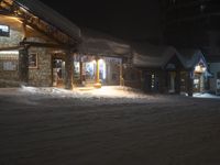 an outside area covered in snow and lights at night time at a resort or resort