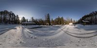 a 360 - view shot of a snowy park and the trees are covered in snow