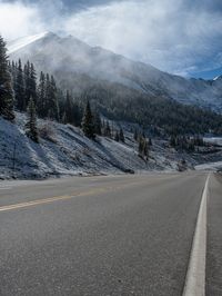 A Snowy Road in Colorado: Mountains and Forest in View