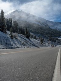 A Snowy Road in Colorado: Mountains and Forest in View