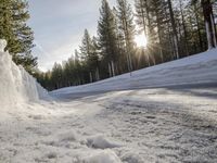 a long country road is covered with snow and has a person riding a ski on it