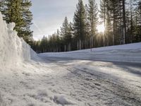 a long country road is covered with snow and has a person riding a ski on it