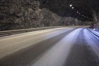 a street is shown with snow on the road and two lines in the tunnel where there is something under