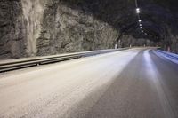 a street is shown with snow on the road and two lines in the tunnel where there is something under