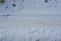 there is an aerial view of a snowy road in the middle of a barren field