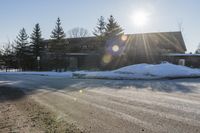 Snowy Road: Residential Buildings and Trees in Ontario