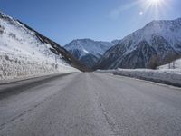 Snowy Road Through the Alps: A Winter Landscape in Switzerland