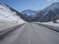 Snowy Road Through the Alps: A Winter Landscape in Switzerland