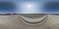 a 360 degree photograph of a train at a railway station from an angle as seen from the bottom of an incline