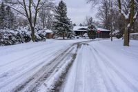 a snowy sidewalk with a stop sign on it in the middle of a neighborhood,