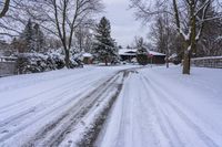 a snowy sidewalk with a stop sign on it in the middle of a neighborhood,