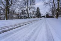 a snowy sidewalk with a stop sign on it in the middle of a neighborhood,