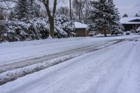 a snowy sidewalk with a stop sign on it in the middle of a neighborhood,