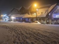 the ski lodge is lit up for the evening in the foggy snowy snow storm