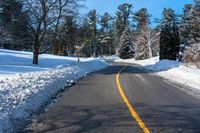 the side of a road is covered in snow, with a sign for green mountain park