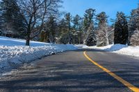 the side of a road is covered in snow, with a sign for green mountain park