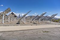 a row of solar panels on the ground of a solar park in the desert setting