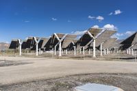 a row of solar panels on the ground of a solar park in the desert setting