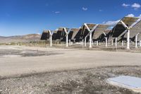 a row of solar panels on the ground of a solar park in the desert setting