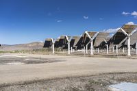 a row of solar panels on the ground of a solar park in the desert setting