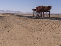 the train is traveling down the railroad tracks in the desert area of the area where the trains are parked