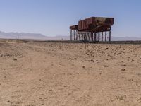 the train is traveling down the railroad tracks in the desert area of the area where the trains are parked