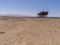 the train is traveling down the railroad tracks in the desert area of the area where the trains are parked