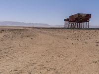 the train is traveling down the railroad tracks in the desert area of the area where the trains are parked