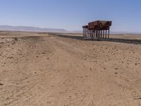 the train is traveling down the railroad tracks in the desert area of the area where the trains are parked