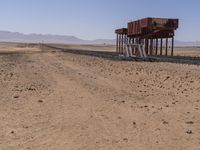 the train is traveling down the railroad tracks in the desert area of the area where the trains are parked