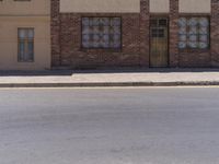 a building with the sign that reads to the right of the road is a closed street, with a yellow line on the road in front of it, and some buildings