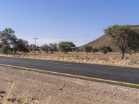 there is a large empty road with some mountains in the background in the desert areas