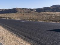 there is a sign in the middle of a desert road to remind someone who's missing