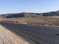 there is a sign in the middle of a desert road to remind someone who's missing